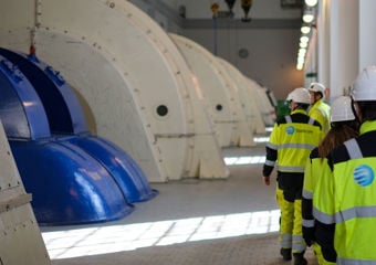 Employees in protective gear are entering the inside of a hydropower plant